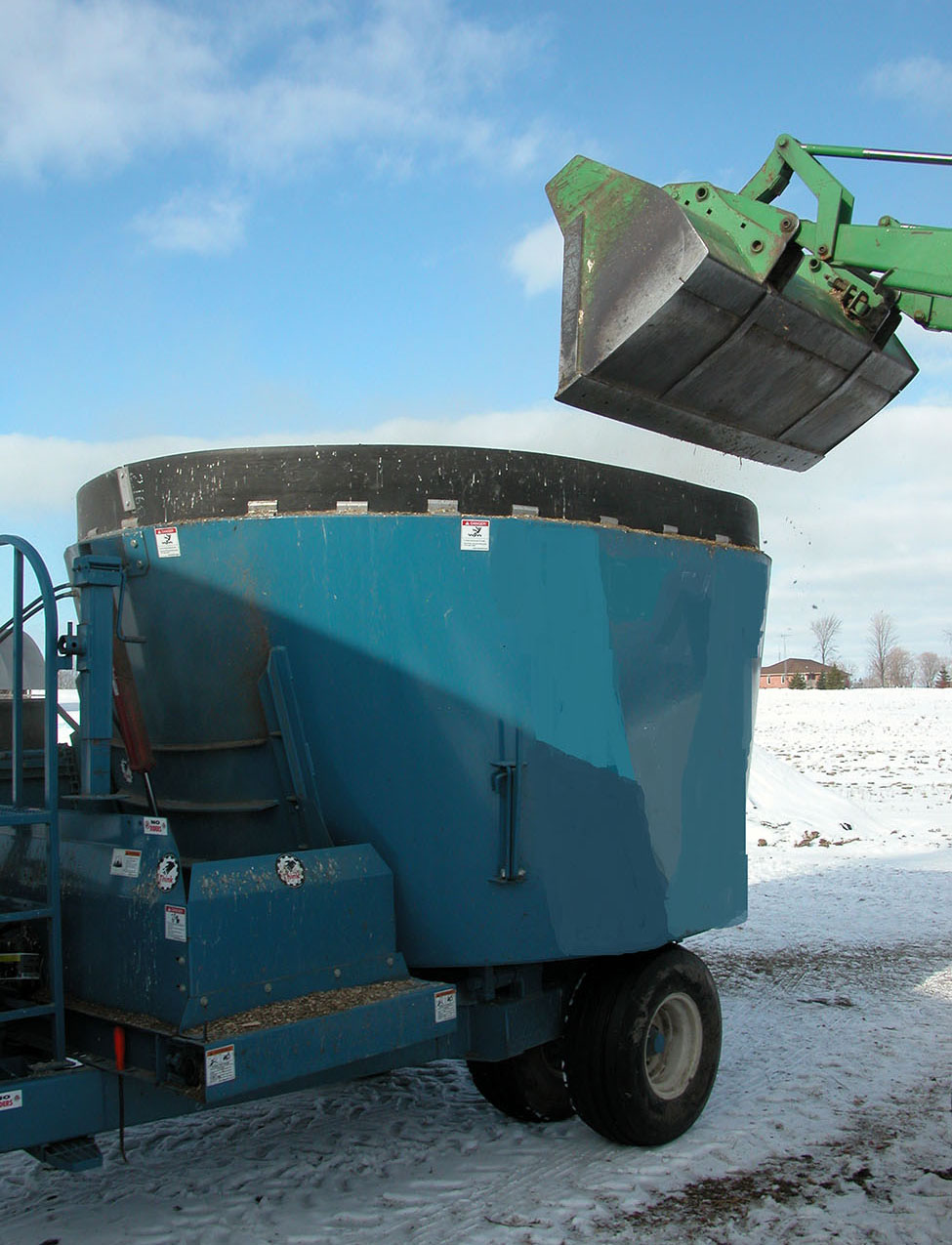 A vertical TMR mixer that is used to make rations consisting of commodity feeds, silages and hay.