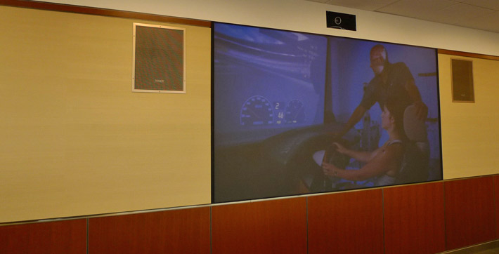 Photo of the 104 inches by 60 inches high definition projector screen in the Seminar Room