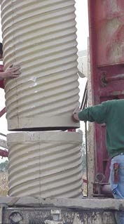 Picture showing two large fibreglass casing pipes being fitted