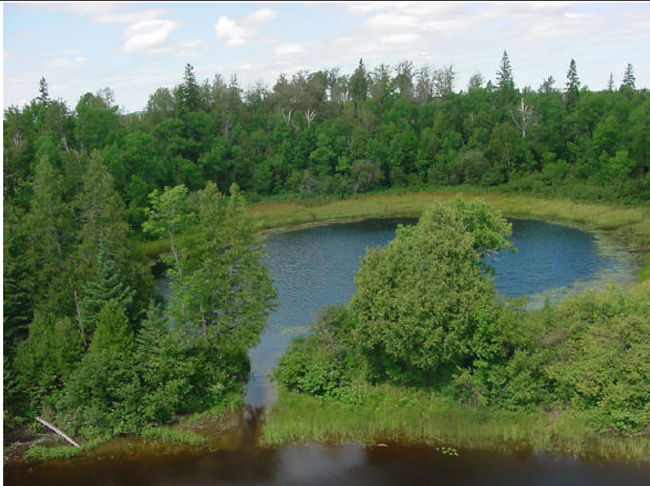 Photograph of small pond attached by a channel to the Montreal River