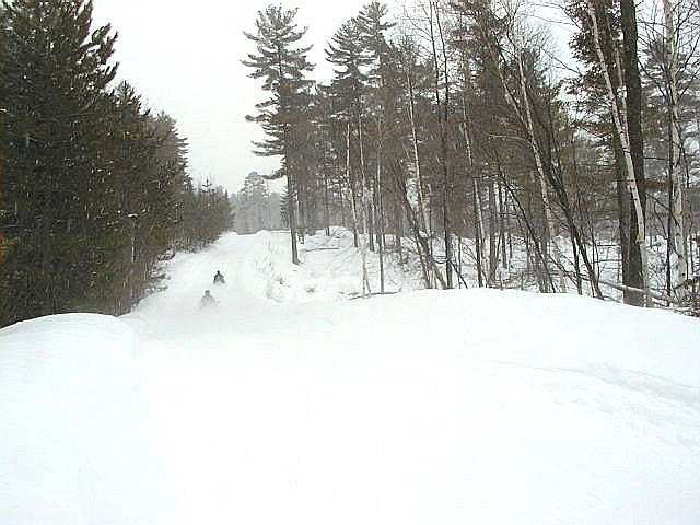 Photo of Individuals snowmobiling on a OFSC TOPS A Trunk Trail, along the southern boundary of the conservation reserve