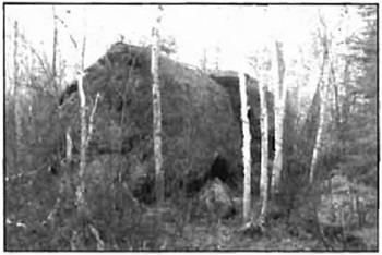Greyscale photo of a large, erratic boulder.