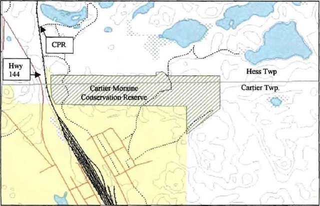 Site map of Cartier Moraine Conservation Reserve showing this Conservation Reserve surrounded by the Townships of Cartier and Hess. Water bodies are indicated with blue. The Canadian Pacific Railway is indicated by a black line with tick marks and Highway 144 is also indicated.