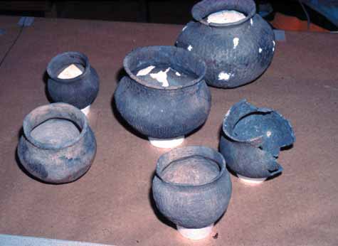 photgraph of six grey pots.