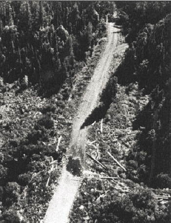 Black and white photo showing a road washout.