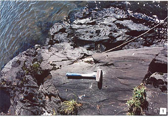 This photo shows pillow lavas of the Eagle Lake volcanics, Lone Pine Well- preserved pillows are at the top of the photo, while hammer lies on sheared rocks.