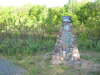 This is a photo of a cairn that commemorates the successful restoration of the Eastern Wild Turkey in Ontario.