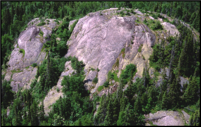 Figure 5: Rounded hill with bald bedrock crest. Probable evidence of wave-washing. Photograph by Allan Harris.
