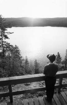 Photo of young boy looking at a lake