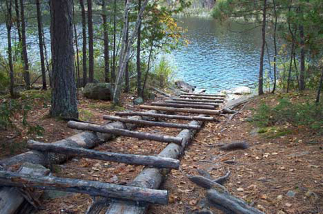 This is figure 4 displaying a log portage structure on portage at Gibraltar Narrows