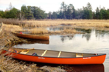 This photo shows canoes at the waters edge at Muskrat Creek .