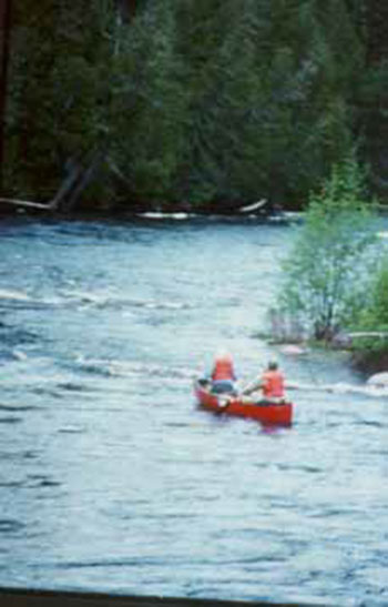 This photo shows two men Paddling the Missinaibi.