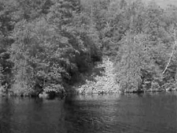 Black and white photo of a talus slope on the shore of Mistinikon Lake.