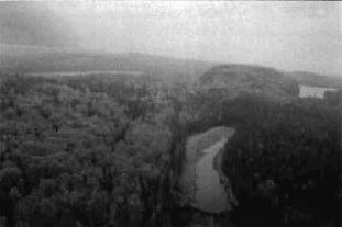 Black and white photo showing a general view approximately north into the south central part of the conservation reserve. Bedrock terrain, essentially a complex of bedrock-controlled uplands and adjacent lowlands, dominates the surficial geology of the conservation reserve.