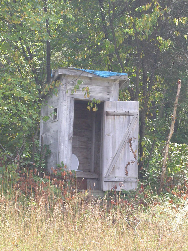 This photo shows Outhouse found at the access point and boat launch of Mozhabong Lake.