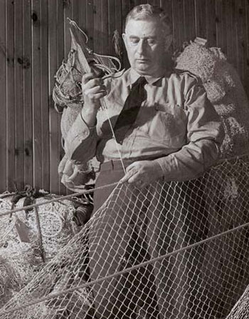 black and white photo of repairing nets at the Ontario Department of Lands and Forests southern research station at Maple.
