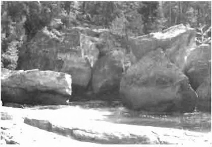 This is figure 5 photo of boulder deposits featuring layers of puddingstone, next to the upper falls. 
