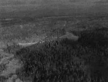 black and white photo of the main snowmobile trail between Englehart and Larder that makes up a portion of the southern edge of the conservation reserve and runs through the middle of the forest reserve. Picture shows the snowmobile trail running south to north across two unnamed waterbodies.