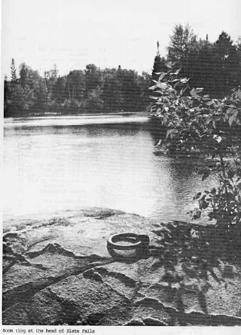 This is a black and white photo of a boom ring attached to a rock at the head of Slate Falls