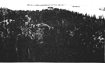 Photo showing View of bedrock ridge behind main beach area, looking westward to Winnange Lake.