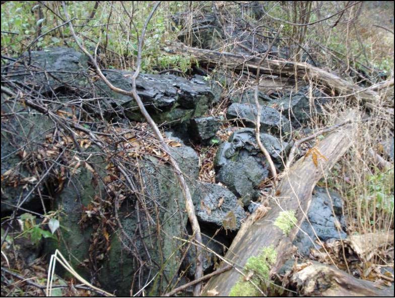Slag-like material on bank of the Oshawa Creek bank east of Site 9