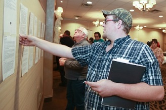 A panelist in Sudbury places his vote for an idea he thinks should proceed to a public vote