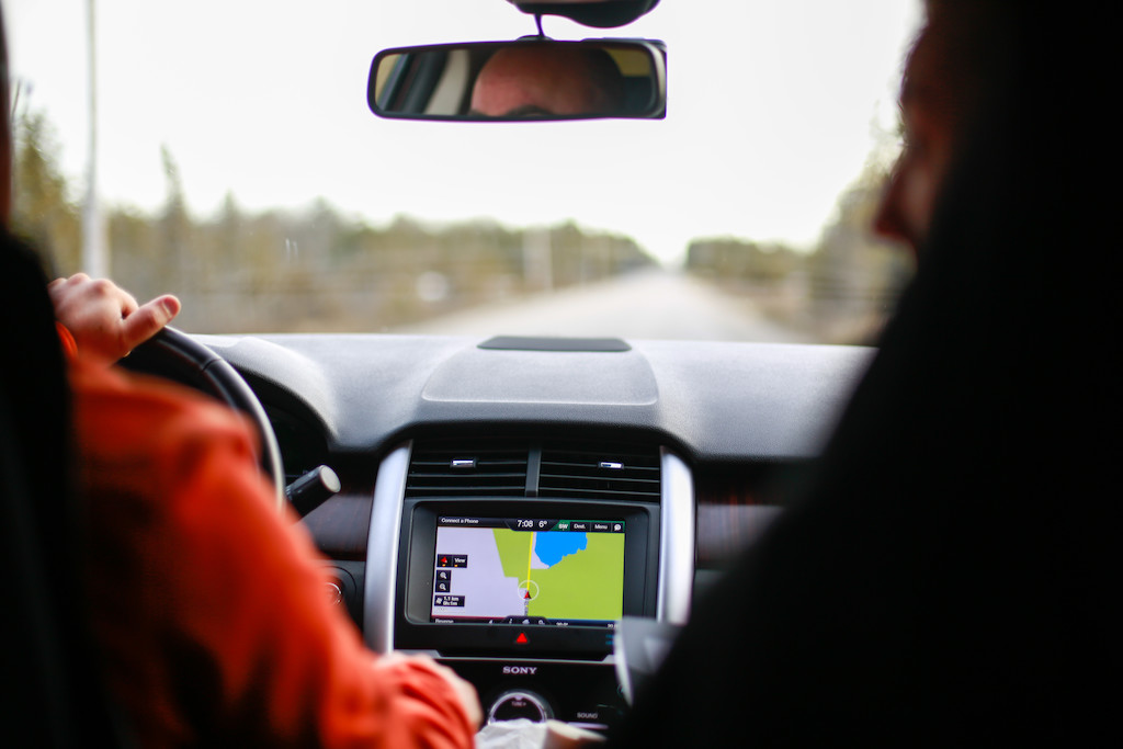 A person driving a car, view from the driver’s seat