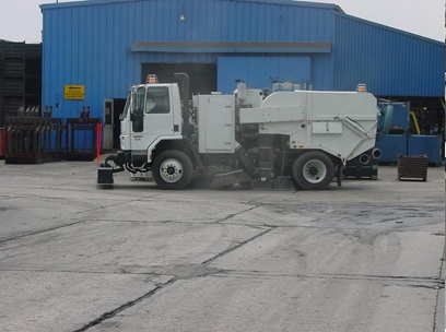 This picture shows an automotive industrial vacuum cleaner, removing deposited fugitives from the ground.