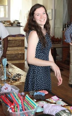 Photo of Amy Kocher, founder of Sew Cool by Amy, pictured with some of her products (jewellery bags and hair ties)