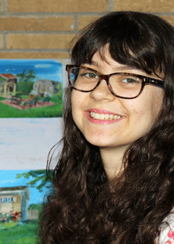 Photo of Samantha Luck, founder of Sam Luck House and Cottage Portraits, pictured with samples of her paintings in the background.