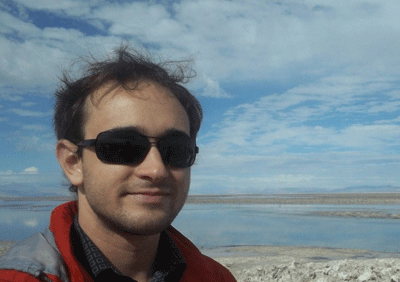 Photo of Avery Campbell, founder of Awarding Canada, with a beach landscape in the background.