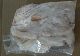of improperly packaged block of frozen fish.