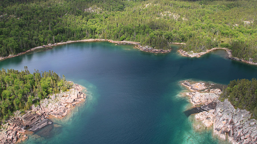 An aerial photograph of a lake and coastal habitat