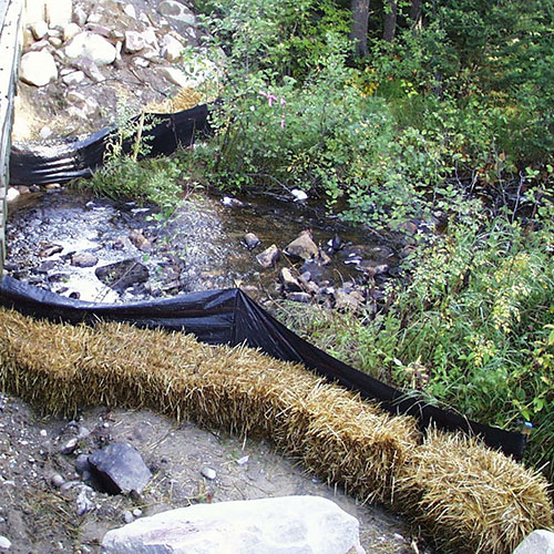 A photograph of a temporary erosion barrier minimizing impacts to stream habitat.