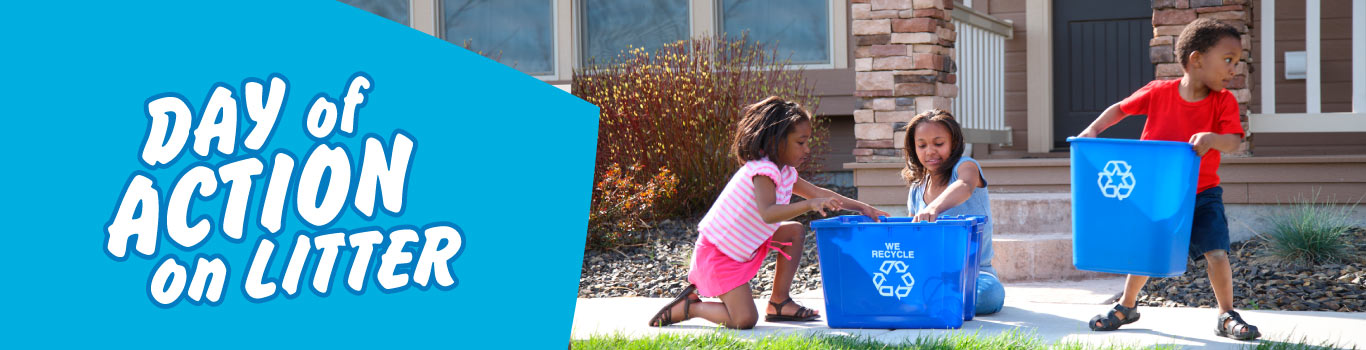 Three kids with two blue recycling bins 