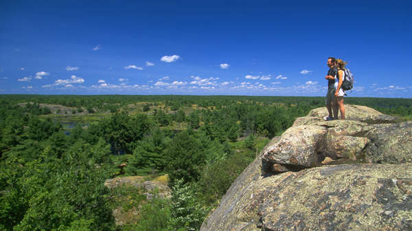 An image showing two people on a cliff