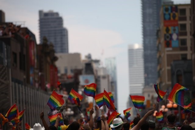 Photograph of a crowd waving rainbow flags in the Greater Toronto Area, World Pride Parade