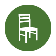 Icône blanche d’une chaise en bois sur fond vert.