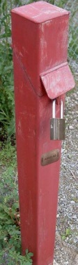 Figure 15-40 is a photograph of a well tag attached to a test hold protective casing.