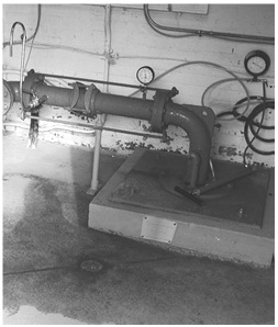 Figure 13-21 shows an image of an inside pump  house with a visible well tag on associated well equipment.