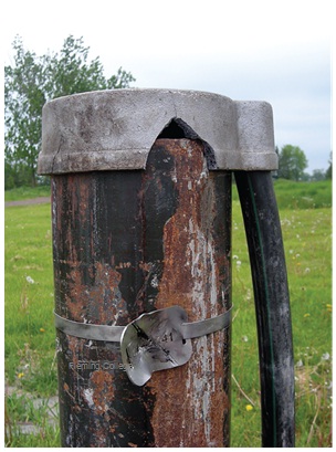 Figure 13-22 shows a well with a broken well tag and a broken well cap.