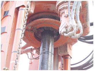 Figure 15-17 shows the upper portion of casing attached to a casing rotator. The casing is raised up the drilling mast.