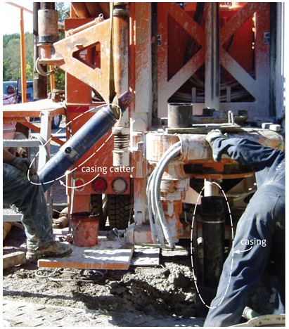 Figure 15-20 shows a blue casing cutter that has been removed from the top head drive of the drill rig. The casing cutter was originally attached to the bottom of drill rods and placed in the well using the drill rig.