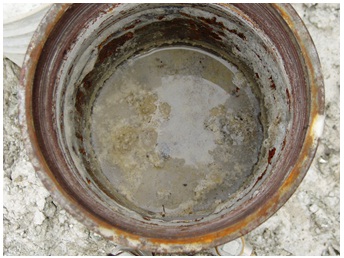 Figure 15-23 shows the view inside a drilled well that has only been partially filled with concrete. There is also an unsealed portion of the well below the concrete plug (not visible).