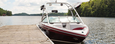Photo of red and white motor boat docked on the water