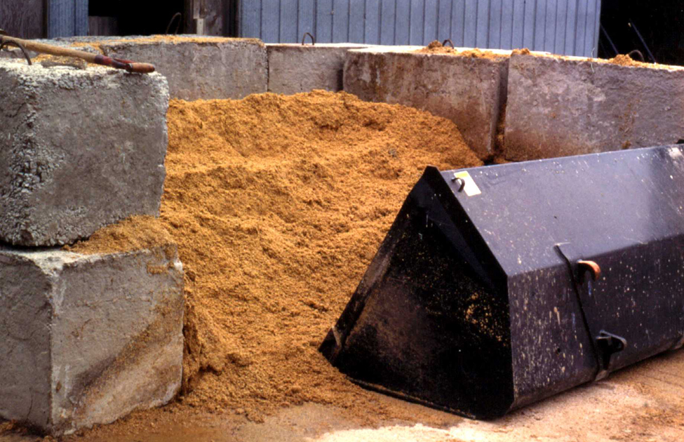 Photo of a compost bin built from large concrete blocks.