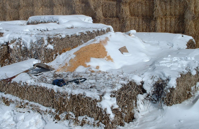 Photo of a compost bin built from large hay bales for walls.
