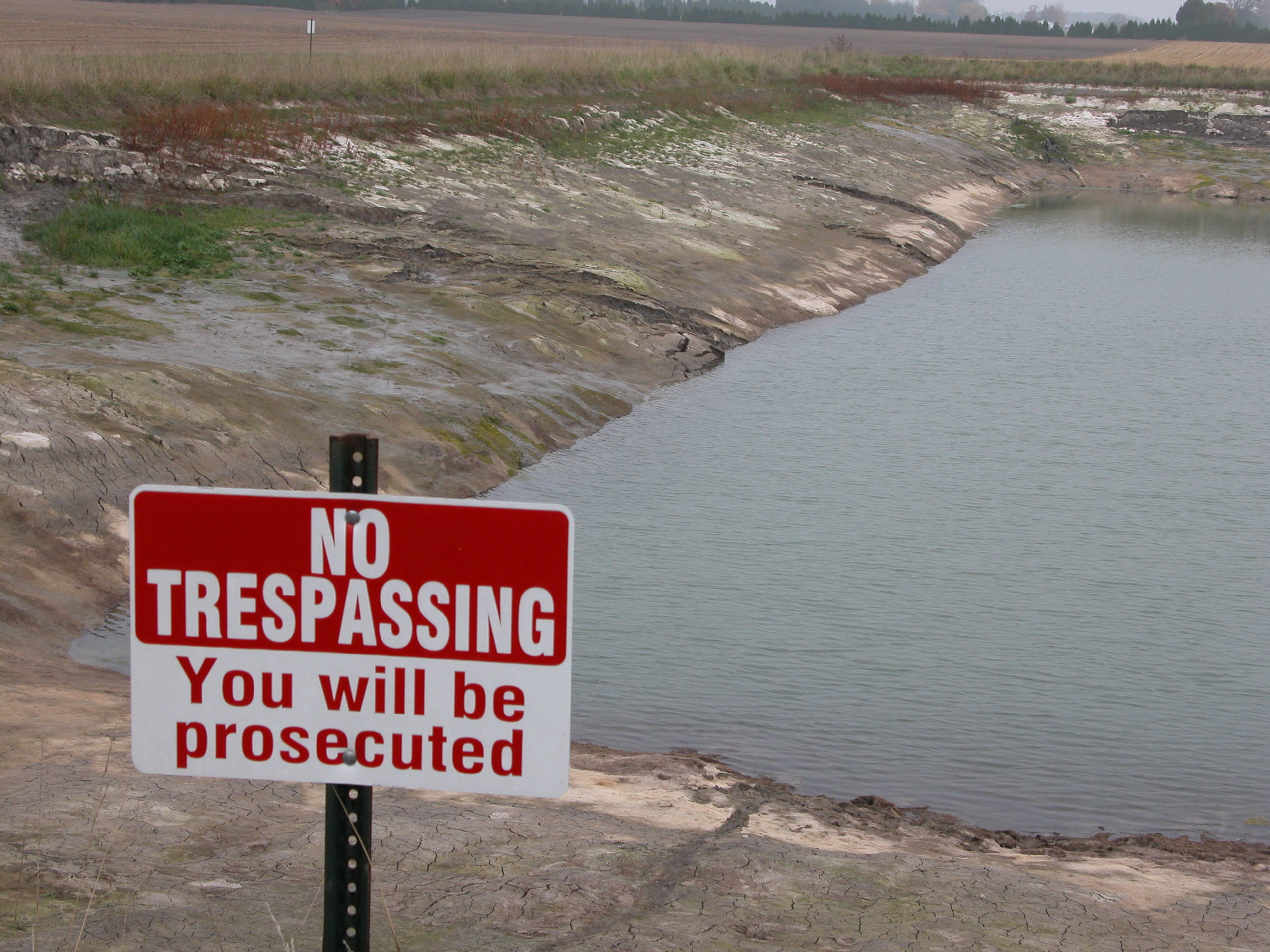 No trespassing sign posted at a reservoir