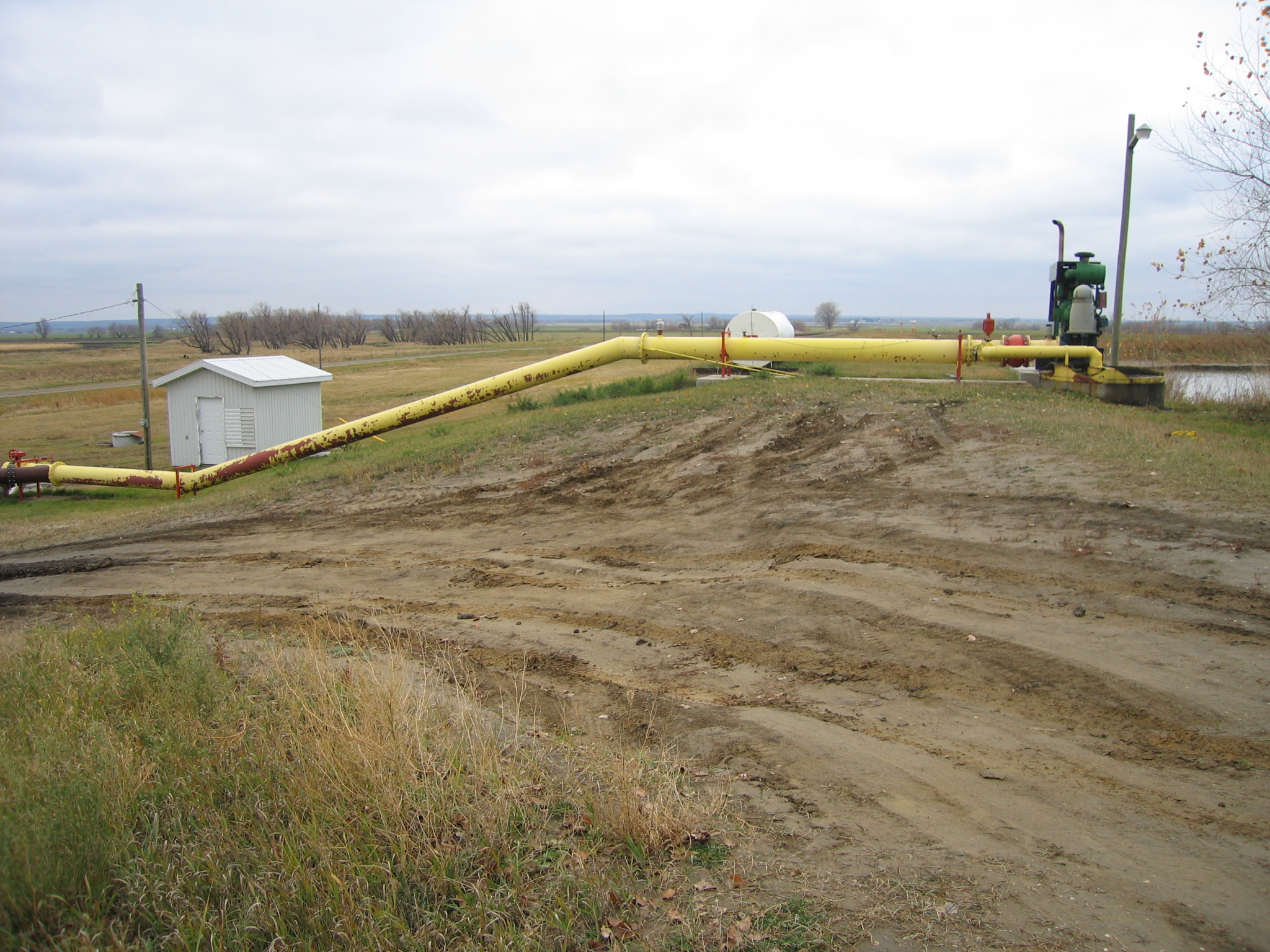 Pipes for filling and emptying the reservoir are placed over top of the berm (rather than through the berm)