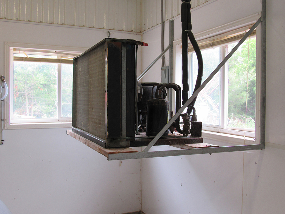 compressor and radiator heater on raised platform in-front of window